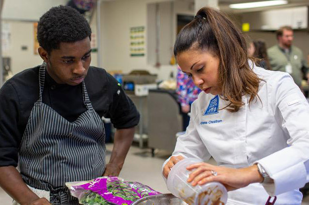 Chef Adrienne Cheatham works on meal with cafeteria staff