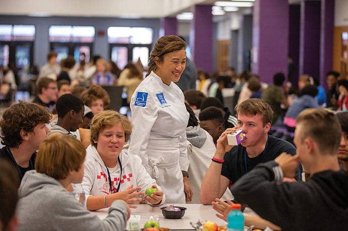 Chef Uno Immanivong talks with students at lunch tables
