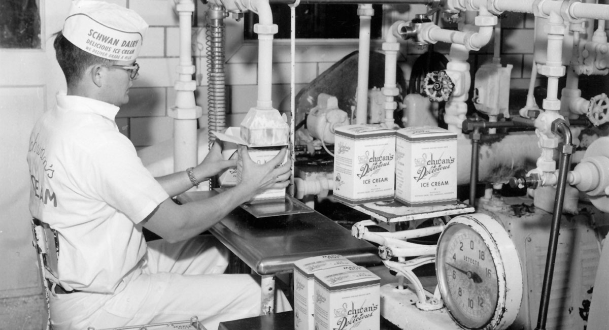 A Schwan's Dairy employee fills an ice cream container